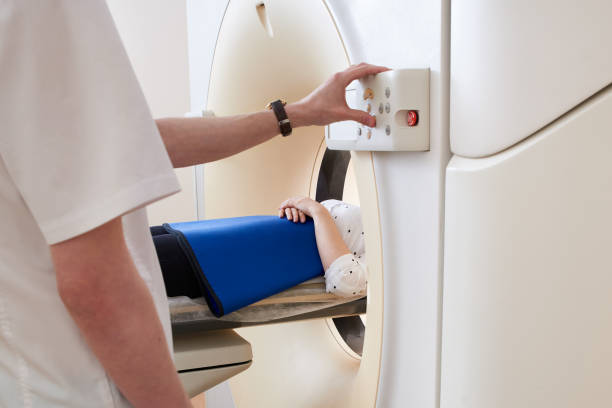 istock Woman going through a Computerized Axial Tomography CAT scanner. Doctor operating mri equipment 1295665544