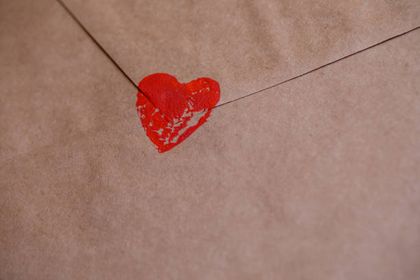 istock Drawing a heart on an envelope with a declaration of love. 1295665707