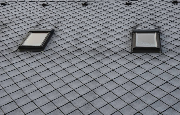 istock gray roof tiles with windows square slate template. laid obliquely. square grid pattern. the lower edge of the roof is formed by a metal strip for framing and better tearing off a layer of snow. 1295666061