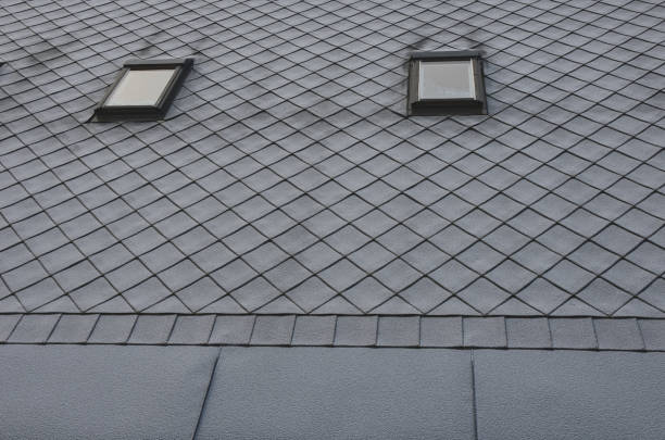 istock gray roof tiles with windows square slate template. laid obliquely. square grid pattern. the lower edge of the roof is formed by a metal strip for framing and better tearing off a layer of snow. 1295666128