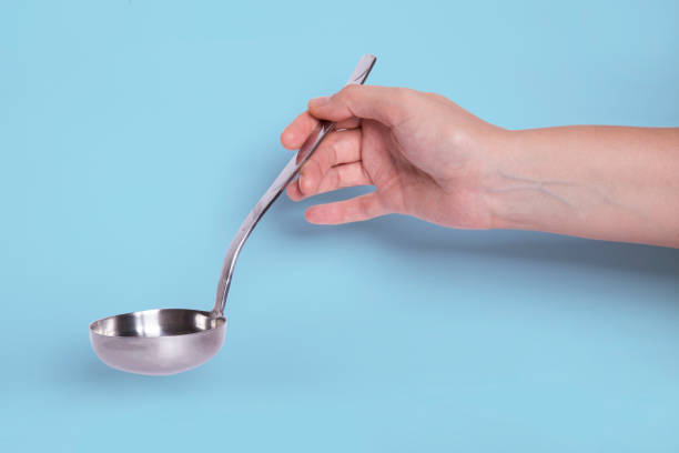 istock Woman's hand holding a ladle 1295667480