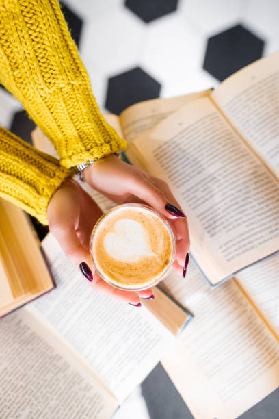 istock Morning coffee with a pattern on the background of books. 1295668534