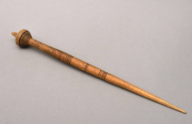old vintage wooden spindle on gray background