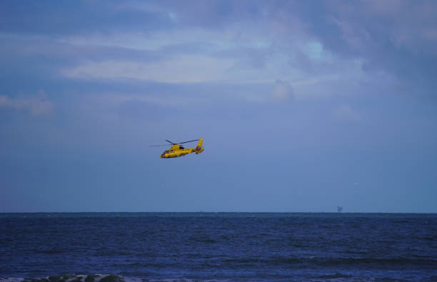 istock a yellow helicopter above water 1295672894