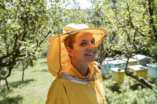 Photo of Portrait of smiling beautiful woman beekeper