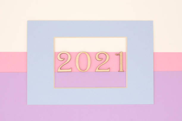 istock blue frame with wooden numbers 2021on a pastel background 1295675085