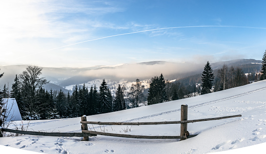panoramic view on snowy landscape  in the Giant Mountains under blue sky