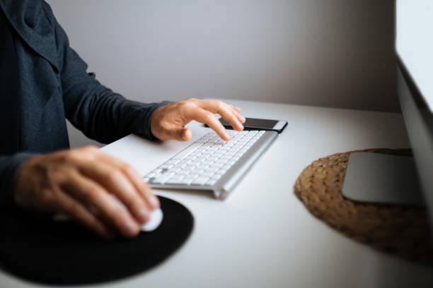 istock Close up of hands typing on laptop. Night work concept. 1295677513