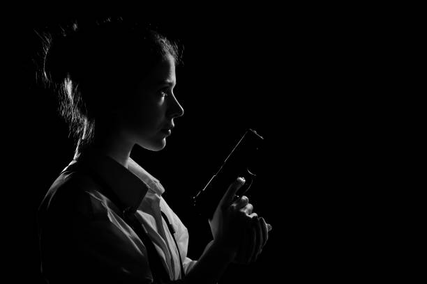 istock woman with gun 1295678808