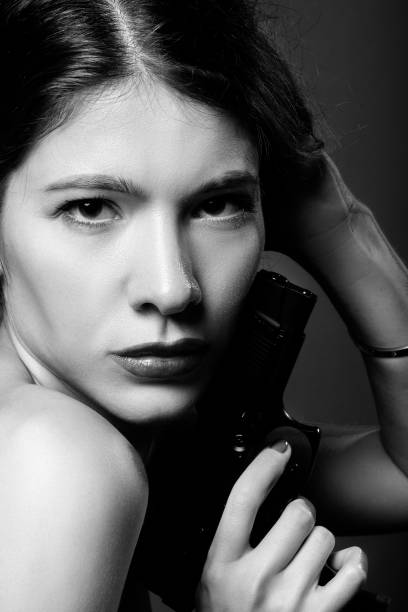 istock woman with gun 1295678943