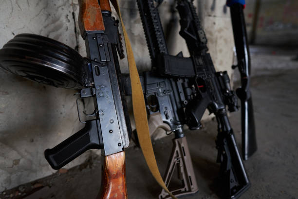 istock Machine gun, rifle, shotgun are leaning against the wall 1295679062