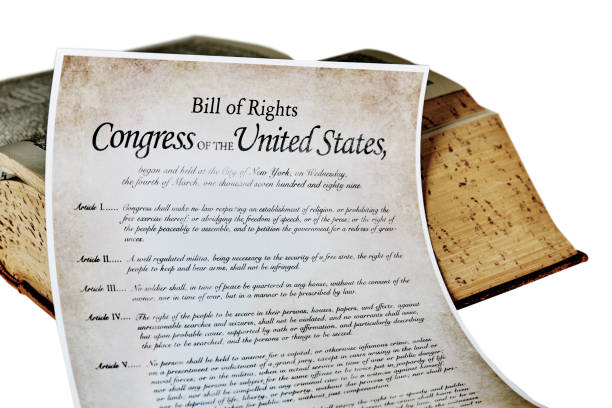 Bill of Rights amendments Close up of a copy of the bill of rights amendments one through four with a vintage book human rights act stock pictures, royalty-free photos & images