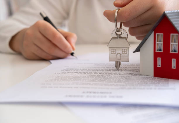 istock Real estate agent giving house keys 1295680464