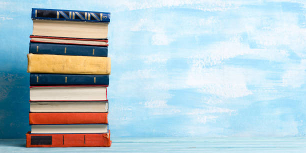 istock Books on wooden desk table and abstract background. Education background. Copy Space. Back to school. 1295681252