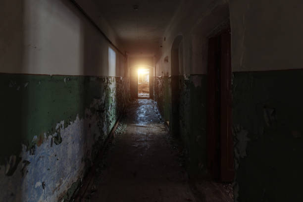 istock Dark creepy corridor of abandoned building 1295681322