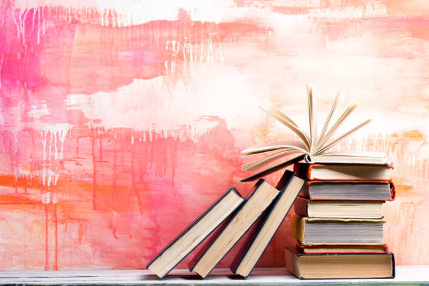 istock Books on wooden desk table and abstract background. Education background. Copy Space. Back to school. 1295681498