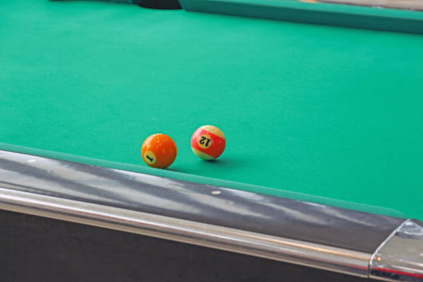 two billiard balls on the table two billiard balls with numbers 1 and 12 on a green table number 12 pool ball ball number stock pictures, royalty-free photos & images