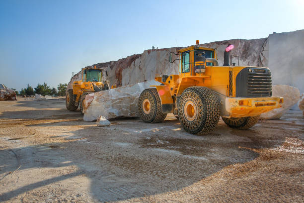 istock Bulldozers carrying an oversized marble block in the quarry 1295684865