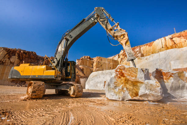 Stone breaker excavator working in a marble quarry