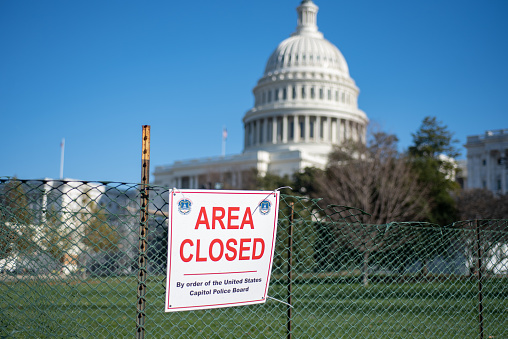 Washington, DC, USA - December, 23, 2020: Area Closed sigh on Fence on blurred United States Capitol Building background.