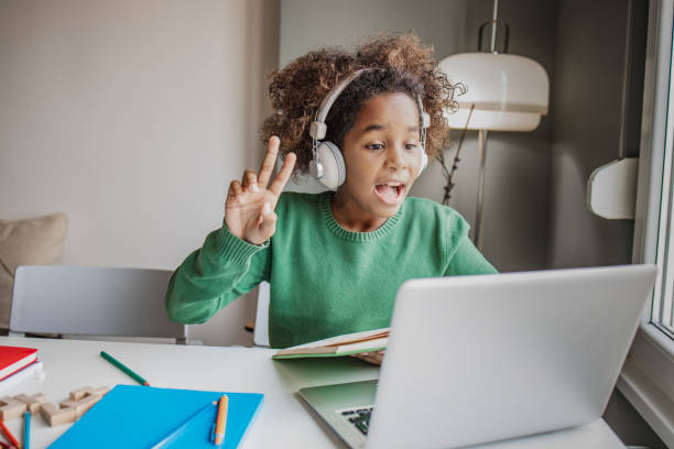 istock Little girl is communicating on a video call with teacher 1295687367