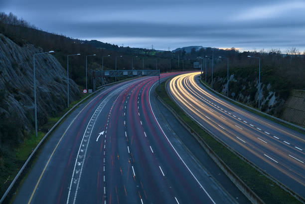 Beautiful very long exposure evening view of light trails of vehicles on motorway M50 Dublin, Ireland stock photo