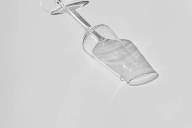 istock Champagne glass on white surface. Glass with shadow on white table. 1295688339