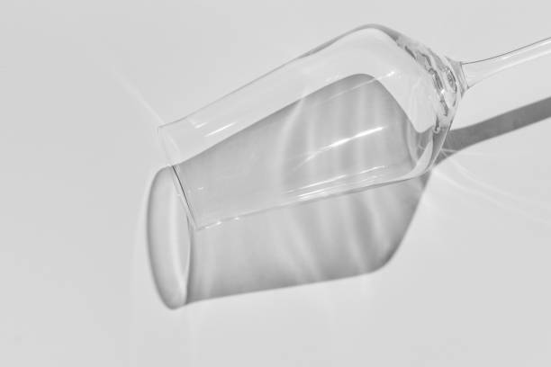 istock Champagne glass on white surface. Glass with shadow on white table. 1295688441