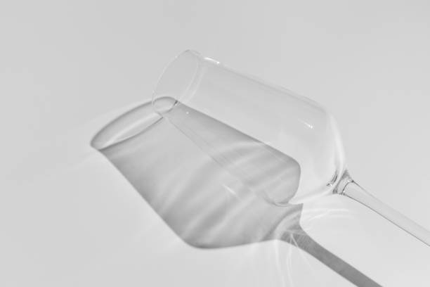 istock Champagne glass on white surface. Glass with shadow on white table. 1295688513