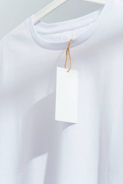 istock White t-shirt with blank price tag, displayed on white hanger 1295688529