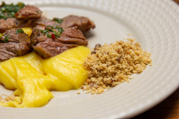 istock Ancho steak with mashed and crispy manioc flour. 1295689635