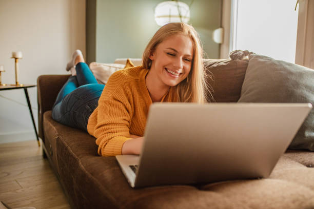 istock Young woman is using laptop at home 1295689738