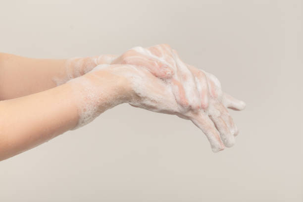 istock woman washing her hands 1295690446