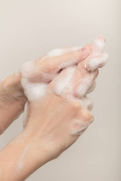 istock woman washing her hands 1295690476