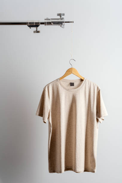 istock Beige t-shirt displayed on a photo tripod 1295690529