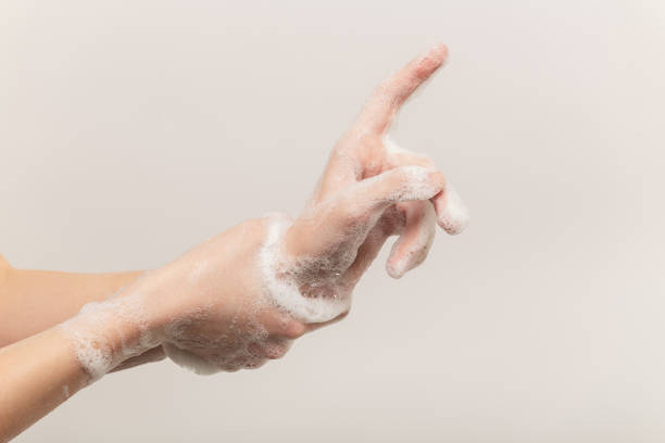 istock woman washing her hands 1295690583