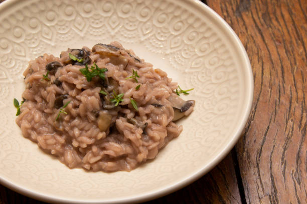 istock Mushroom risotto, on the wooden table. 1295691777