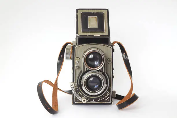 Photo of Vintage twin lens reflex camera with open viewfinder. Front view. Realistic retro design of medium format camera.