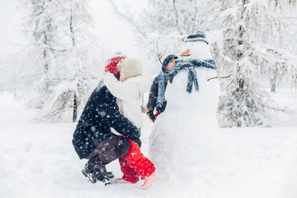 istock Dad With Children Playing In Snow 1295692844