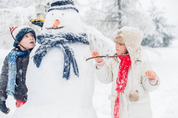 istock Boy And Girl Playing In Snow 1295693560