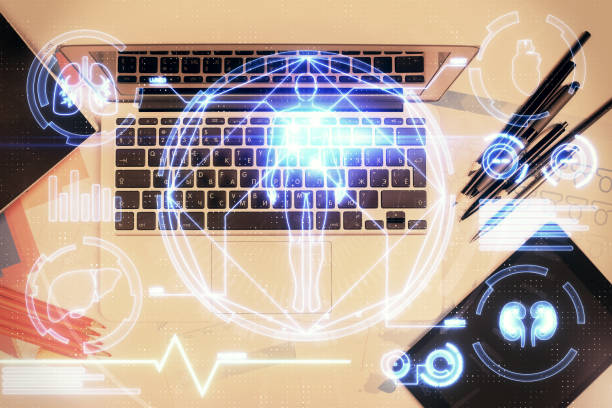 istock Education hologram drawings over computer on the desktop background. Top view. Multi exposure. 1295693684