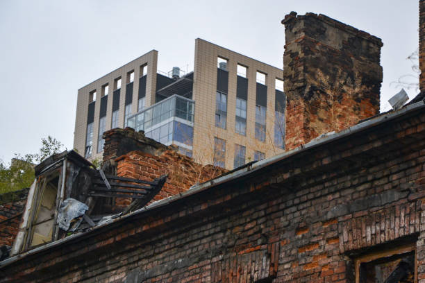 Shot on the details of old ruined tenement house and modern skyscraper on the second plan.