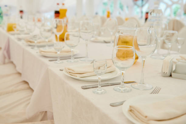 istock Table set with sparkling wineglasses, plates with serviette and cutlery on table, copy space. Place setting at wedding reception. Table served for wedding banquet in restaurant 1295694829