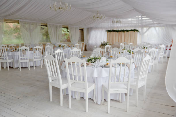 istock Table setting with blank guest card, plates with napkins and cutlery, copy space. Place setting at wedding reception. Round table served for banquet in restaurant 1295694908