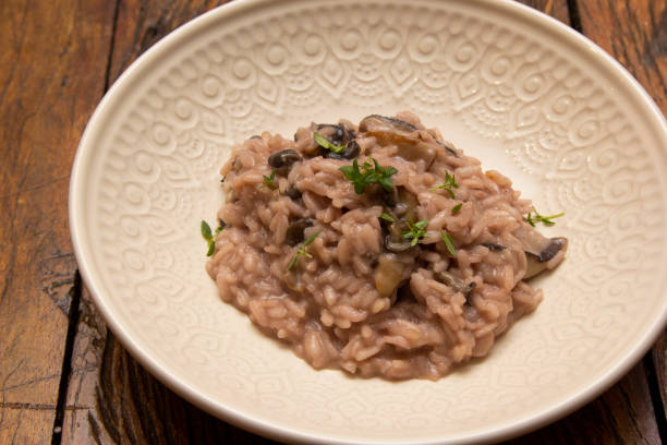 istock Mushroom risotto, on the wooden table. 1295695735
