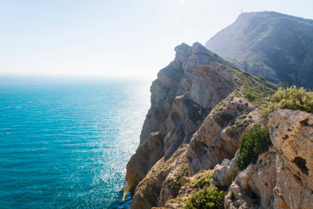 istock Mediterranean landscape with steep cliffs falling into bright ocean at natural park 'Serra Gelada' in Albir, Spain 1295695882