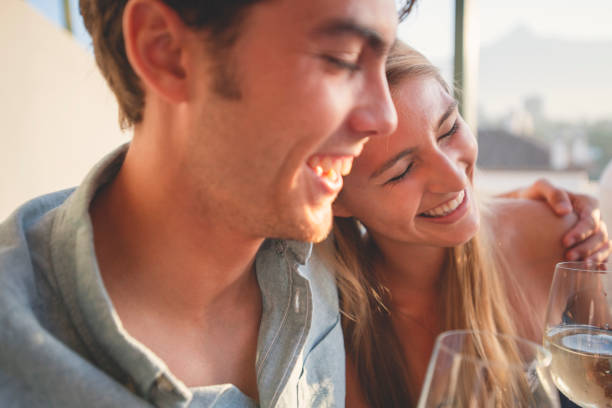istock Couple on a date at as restaurant. They are drinking white wine and having fun. 1295696789