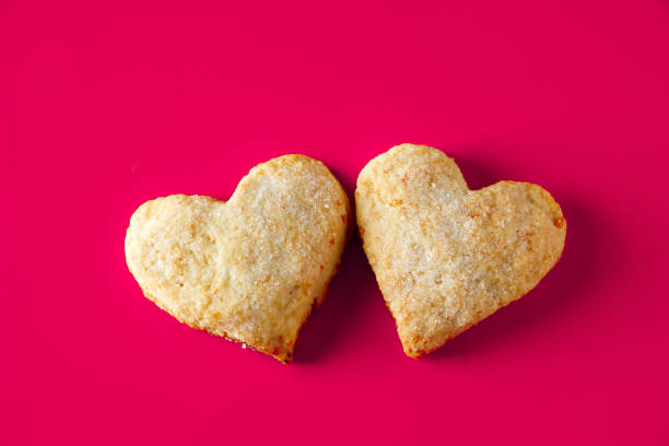 istock Heart shaped cookies for valentines day on pink background 1295701004