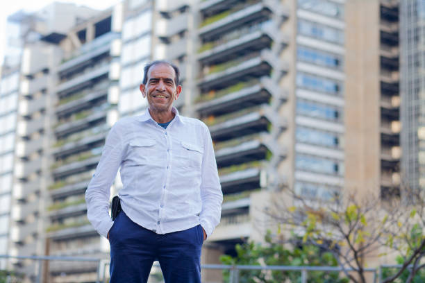 istock 50-year-old Latino man smiles while looking into the camera 1295705154