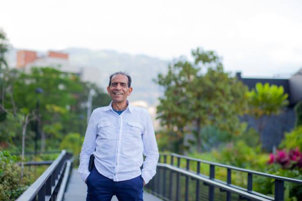 istock 50-year-old Latino man smiles while looking into the camera 1295705158